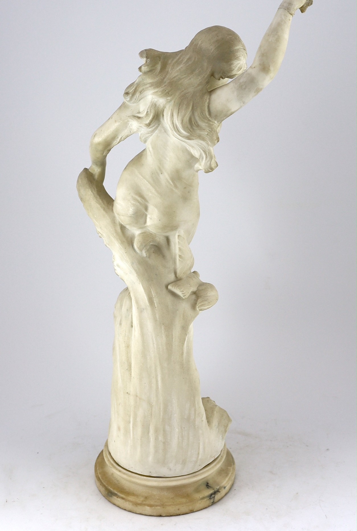 An early 20th century Continental carved white marble figure of a sea nymph riding the waves 79cm high